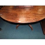 A 19th century mahogany oval topped breakfast table on four reeded down curved legs