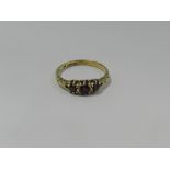 A 9ct gold three stone garnet set ring.