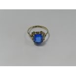 A 9ct yellow gold single stone blue paste ring