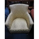 An Edwardian tub chair finished in a gold damask style material