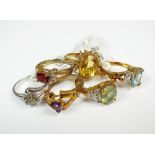 A collection of 9ct yellow and white gold stone set rings to include an amethyst and white topaz