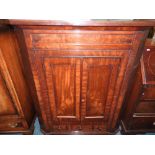 A 19th century mahogany straight fronted cabinet the two cabinet doors over false short drawer