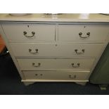 An early 20th century later painted chest of two short over three long drawers raised on shaped