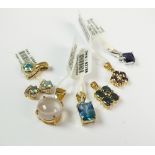 A collection of seven 9ct yellow gold stone set pendants to include a topaz set example,