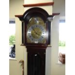 A reproduction three train longcase clock with glass door,