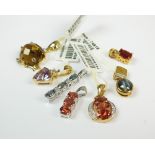 A collection of seven 9ct yellow and white gold stone set pendants to include a quartz set example