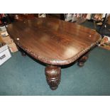 A Victorian Elizabethan style oak dining table with fixed carved top on cup and cover legs