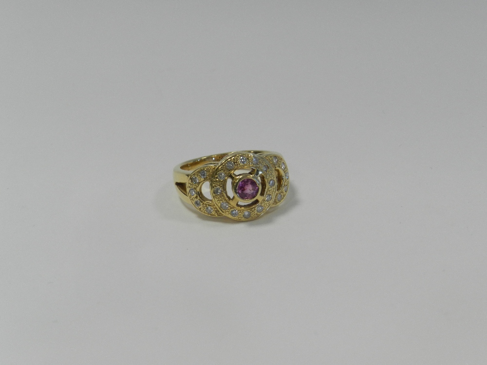 A pink sapphire and diamond dress ring,