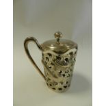 A Chinese silver openwork beaker holder with removable cover