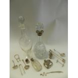 A silver mounted cut glass decanter together with a further glass decanter,