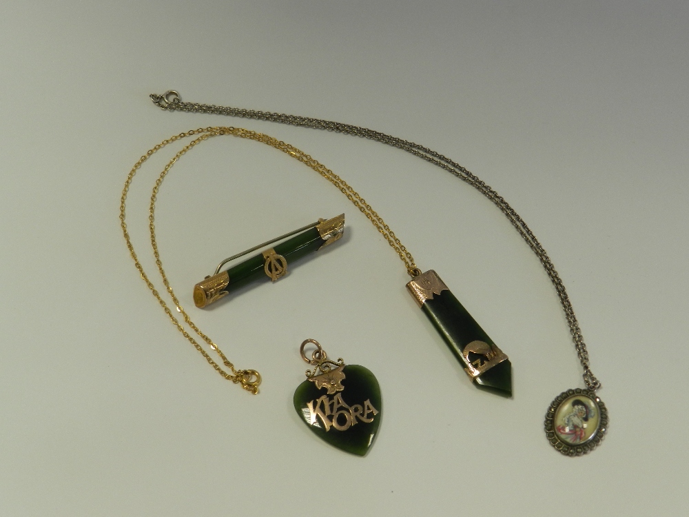 A jadeite set bar brooch together with a pendant,