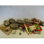 A tray containing various silver backed dressing table brushes and a quantity of costume jewellery,