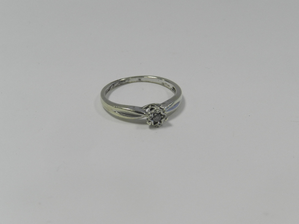 A 9ct white gold single stone diamond ring within star illusion set mount.