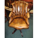 A 20th century leather button back swivel office armchair