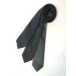 Three ties to include black skinny examples, one with white dot and one with metallic thread,