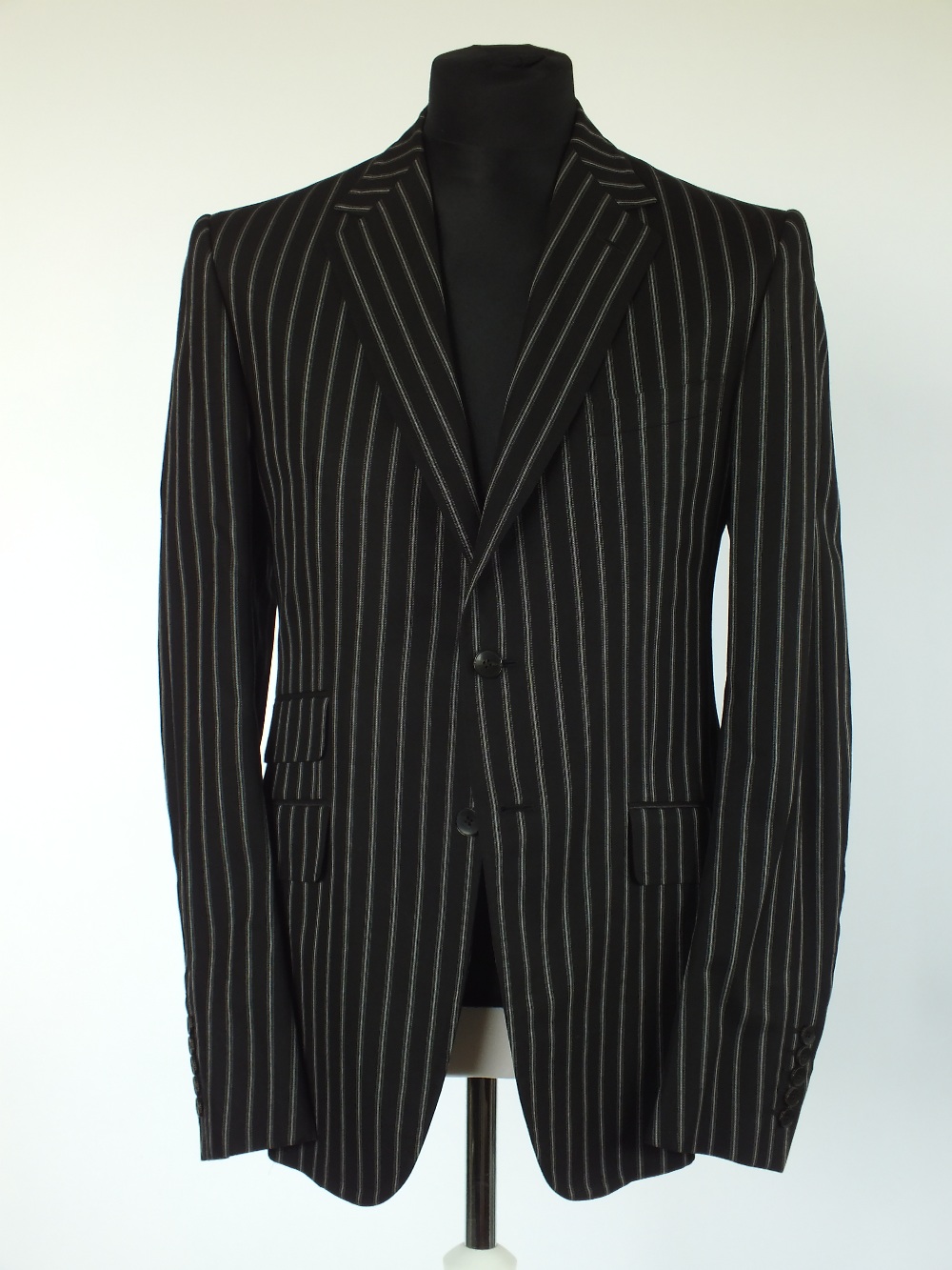 A Gucci jacket, black with white pinstripe, single vent, lined, Italian size 52L, 100% cotton