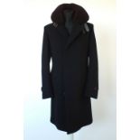 A Gucci coat, black with detachable brown shearling collar, lined, single vent, buckle detail to