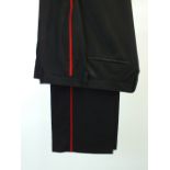 A pair of Gucci evening trousers, black with raw edge waistband and belt loop and fly detail, flat