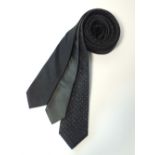 Three black skinny ties, one black crinkle with silver dot, black with a silver stripe, one black