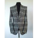 A Gucci dinner suit, black with white patterned fabric, double vented, Italian size 52R, 70% silk,