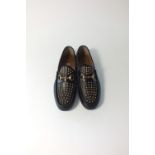 A pair of Gucci traditional loafers, black leather with brass horse bit detail and with pointed