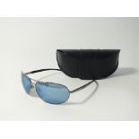 A pair of Police sunglasses, dark metal frames in aviator style with mirror lenses, logo to