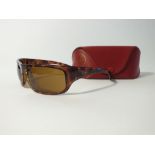 A pair of Ray Ban brown tortoiseshell sunglasses in red case