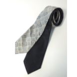 Two Gucci ties, one black with watermark pattern, one grey woven check with Gucci G pattern