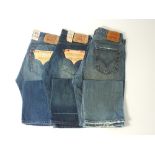 Three pairs of Levi 501 jeans, dark blue, two with tags, 34/34