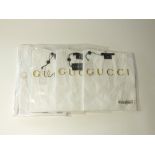 Four Gucci t-shirts, white, two v-neck and two round neck, one with signature detail to pocket, size