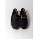 A pair of Gucci shoes, textured black leather with Gucci brass horse bit, size UK 8.5