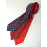 Three navy and red ties, red with blue spot, blue and red woven pattern print and a blue with red