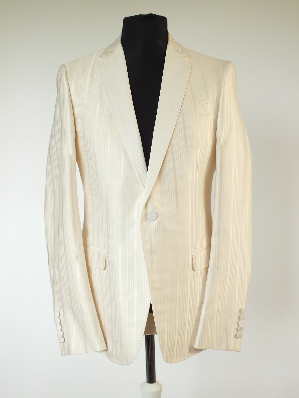 A Gucci dinner suit, cream, self strip with twill lower lapel, single vent, Gucci G embroidered to