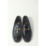 A pair of Gucci black textured patent detail loafers, brass horse bit detail, UK 8.5, show signs