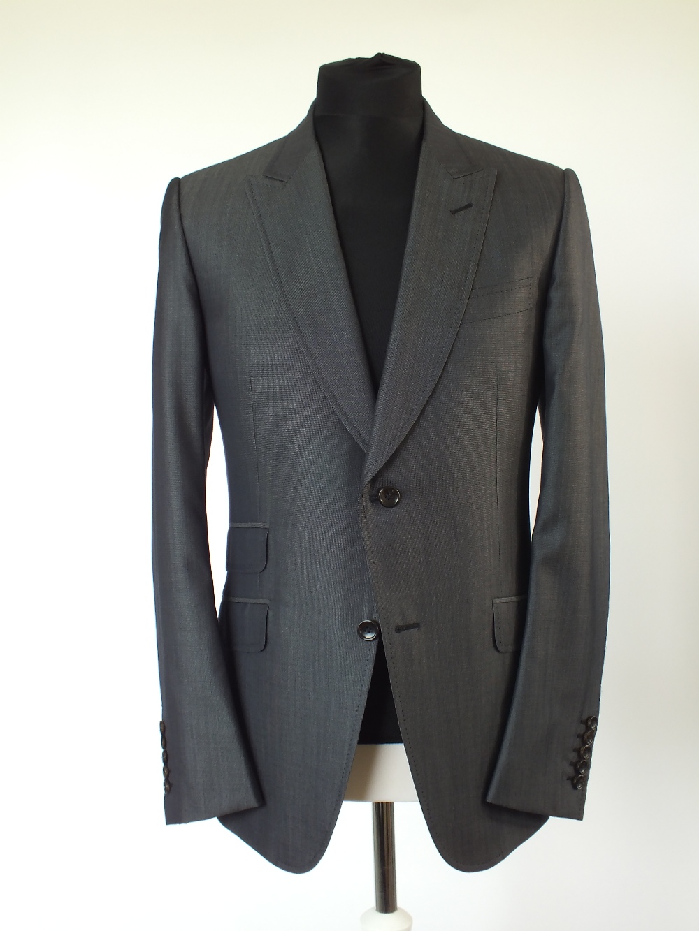 A Gucci suit, dark grey, double vent, with horse bit woven lining, Italian size 52R, 60% wool, 40%