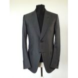 A Gucci suit, dark grey, double vent, with horse bit woven lining, Italian size 52R, 60% wool, 40%