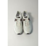 A pair of Gucci trainers, white with Gucci ribbon detailing Gucci logo in black rubber detailing, UK