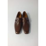 A pair of Gucci slip-on loafers dark tan leather with Gucci logo, leather strap detail, EU 42E