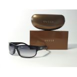 A pair of Gucci sunglasses in case and box