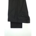 A pair of Gucci trousers, black, Gucci metal logo detail to pocket, flat fronted button fly, Italian