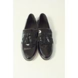 A pair of Gucci slip-on evening loafers, black patent leather, tasseled in many ways, embossed Gucci