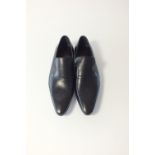 A pair of Gucci slip-on black leather shoes, with unstamped brogue detailing, EU 42E