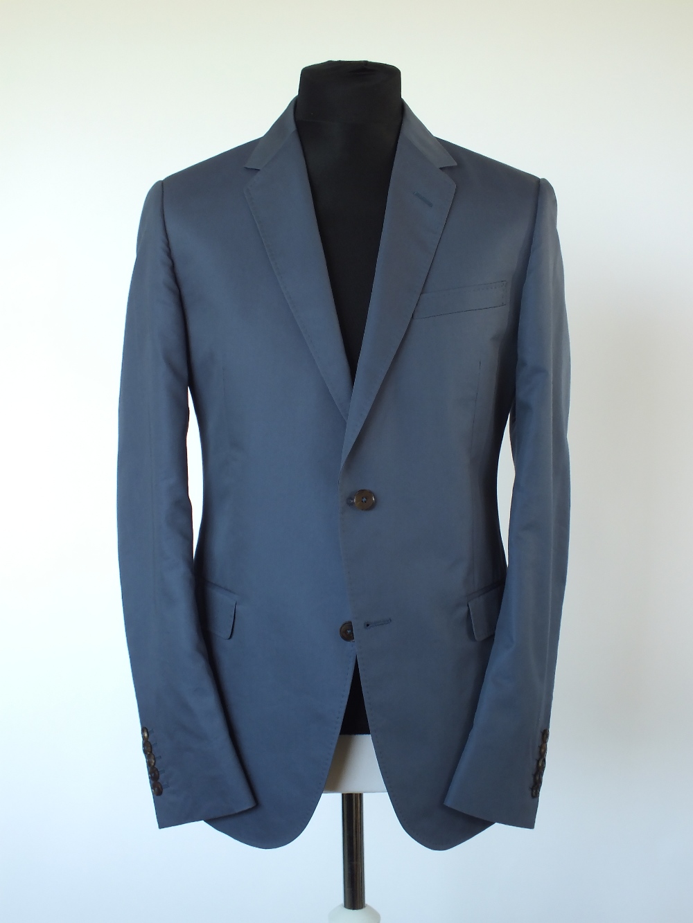 A Gucci suit, mid blue, lined in black, Italian size 52R, 65% cotton, 35% silk, flat front to