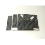 Four black Gucci t-shirts, three v-neck and one round neck, all packaged, size XL