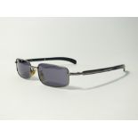 A pair of D&G sunglasses, dark metal skinny frames, grey lenses, metal and black plastic temples