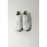 A pair of Lacoste trainers, white leather, velcro fastening, some marking to upper, UK 9