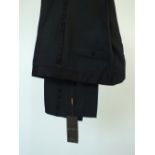 A pair of Gucci evening trousers, satin detailing, unfinished hem, black slubbed fabric with tags,