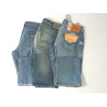 Three pairs of blue jeans to include Levi 501 with tags, another set of 501 and a pair of Prada