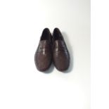 A Gucci driving shoe style, dark brown embossed leather with Gucci logo embossed pattern and Gucci