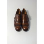 A pair of Gucci slip on shoes, mid brown, burnished, plain brogue detailing with strap and silver